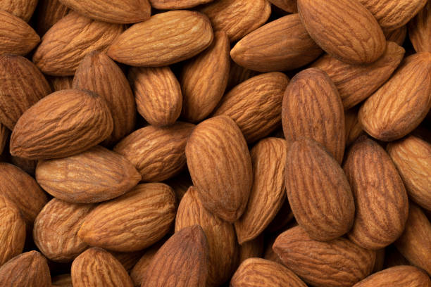 istock Peeled brown almonds close up full frame 1319794457