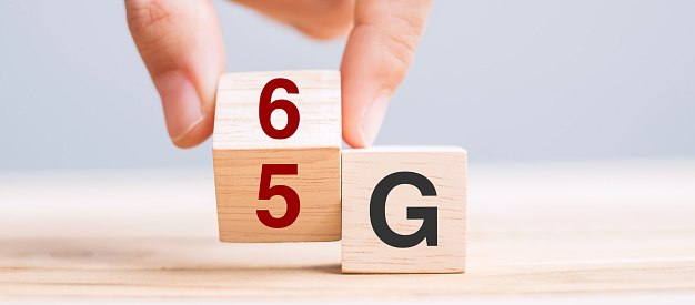 Businessman hand change wooden block from 5G to 6G (Generation of Cellular Mobile Communications) Technology, network, Social media and digital concepts