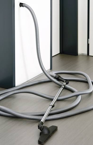 istock Central vacuum cleaner hose in living room 1319794754