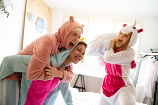 istock Pillow fight with happy women 1319794772