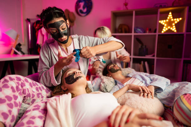 istock Young women getting beauty treatment on a sleepover 1319795647