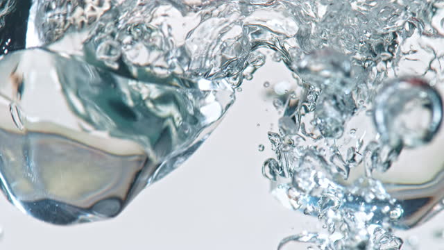 SLO MO LD Ice cubes falling into water