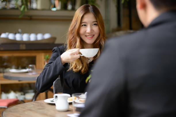 istock Young Woman Drinking Coffee In Cafe 1319798204