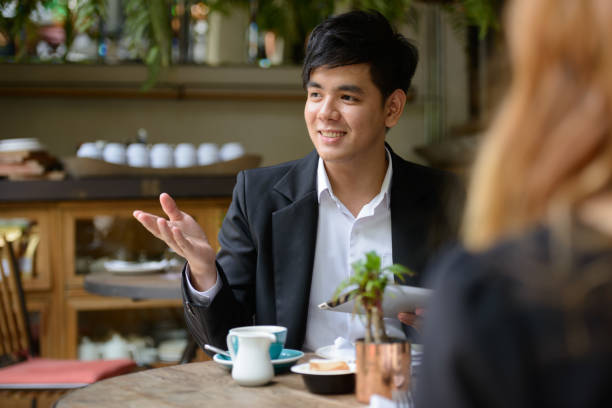 istock Portrait Of Smiling Man Sitting At Table 1319798235
