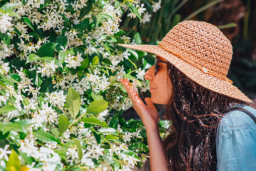 Young Woman Smelling Jasmine Flowers
