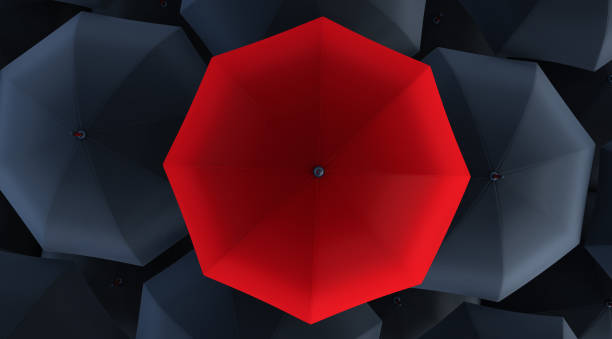 istock 3d render of Unique red umbrella among many dark ones. 1319800898