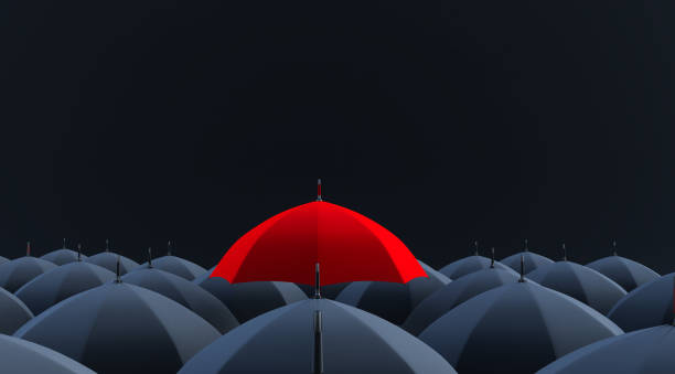 istock 3d render of Unique red umbrella among many dark ones. 1319800899