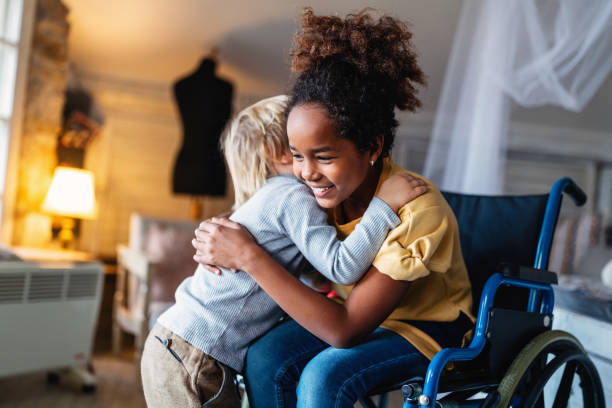 happy multiethnic family. smiling little girl with disability in wheelchair at home - family child portrait little girls imagens e fotografias de stock