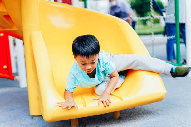 istock Little boy playing on playground equipment 1319802994