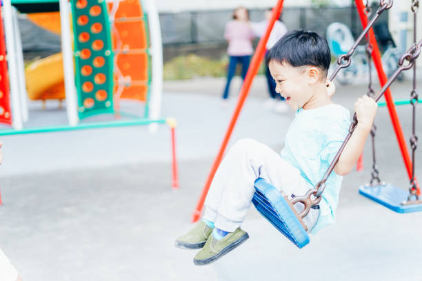 istock Little boy playing on playground equipment 1319802995