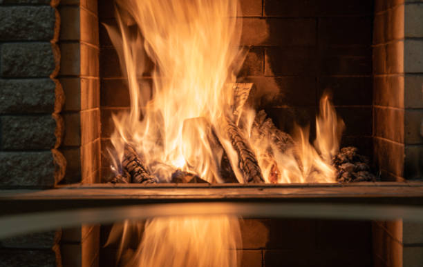 istock Orange Fire burning in cozy fireplace, christmas, winter vacation . 1319804087