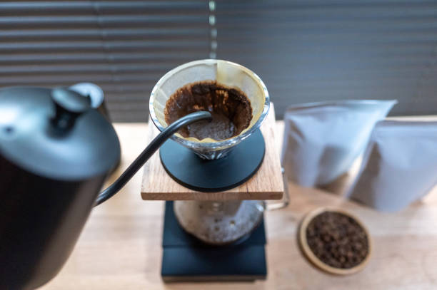 istock Hand drip coffee, Barista making drip coffee with mockup blank package coffee Alternative ways of brewing Coffee shop concept. 1319806070