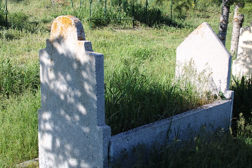 Man praying for dead relative in cemetery