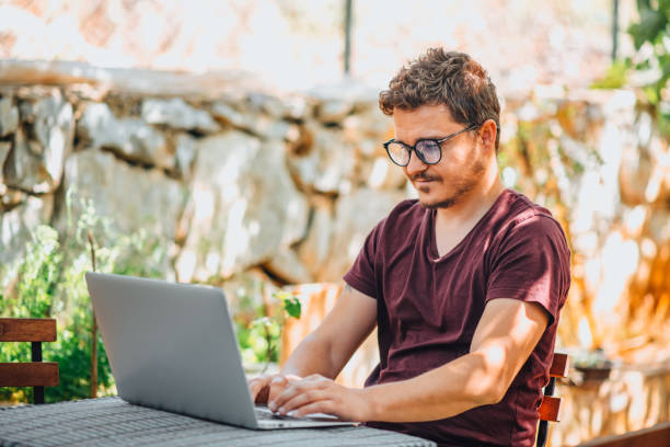 istock Man Working Freelance From His Garden 1319809131