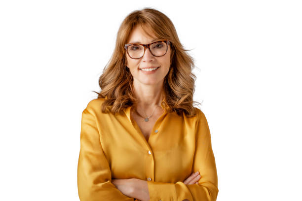 Attractive mature woman studio portrait Studio portrait of middle aged attractive woman standing with arms crossed at isolated white background. Copy space. older blonde woman stock pictures, royalty-free photos & images