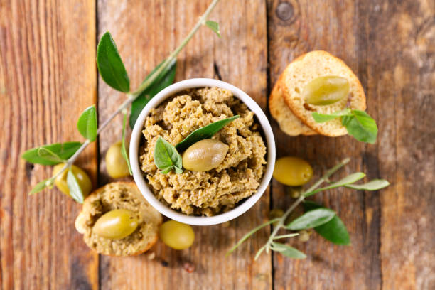 istock green olive tapenade and tree branch 1319812155
