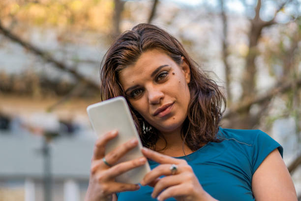 istock A woman using her smartphone outdoors. 1319812287
