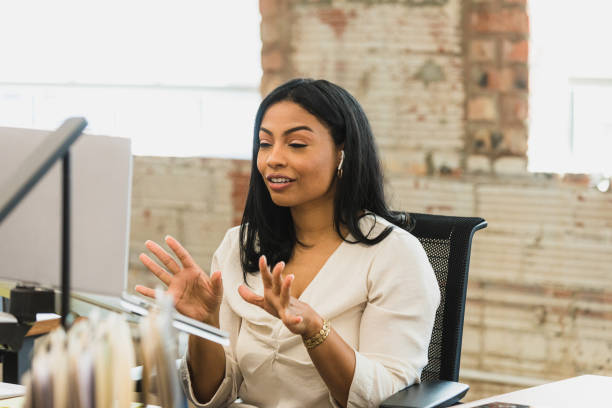 istock Female team lead gestures as she leads virtual meeting 1319813617
