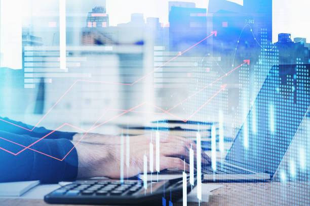 istock Successful trader is sitting at workplace and typing on laptop 1319816943