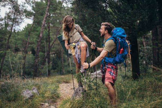 istock Young hikers smiling happy walking in forest during camping travel. 1319817739