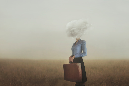 surreal moment of a woman traveler with her head covered by a cloud