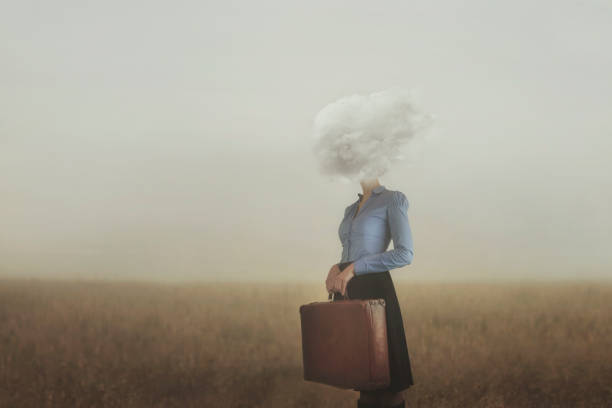 surreal moment of a woman traveler with her head covered by a cloud stock photo