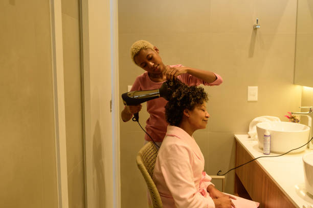 istock A black daughter drying her mother's hair 1319819224