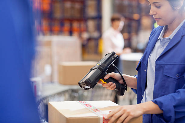 donna lavoratore scansione scatola di cartone con lettore di codice a barre - warehouse bar code reader manual worker working foto e immagini stock