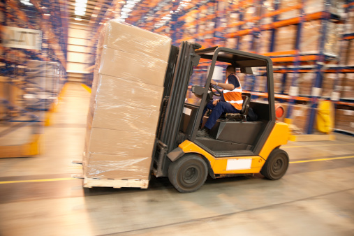 shipping warehouse with cartons and a forklift for handling - industrial interior