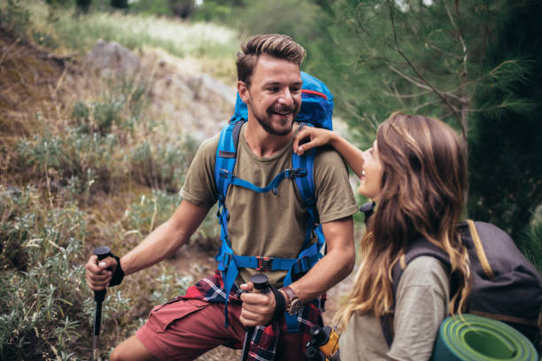 istock Young hikers smiling happy walking in forest during camping travel. 1319820797