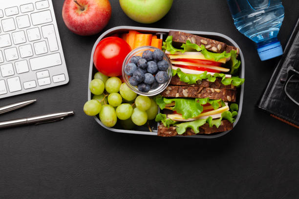istock Healthy office lunch box with sandwich and fresh vegetables 1319820983