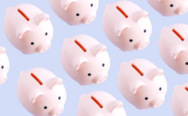 istock Pattern of pink piggy banks top view 1319824781