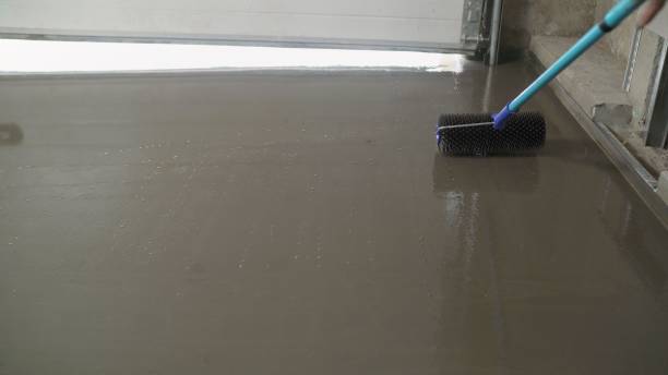 istock Needle roller for self-leveling floors. Leveling the floors with a cement mixture. 1319825283