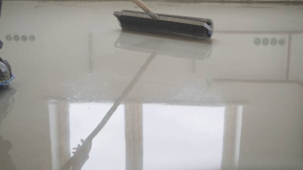 istock Fill the floor with a solution. Filling the floor with a special solution. Filling the surface with a special liquid for leveling the floor. 1319825300
