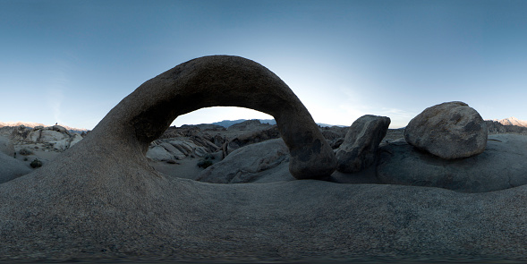 The famous Mobius Arch in Alabama Hills, California. Predawn light and shot with a VR 360 camera. A figure is seen in the far background.
