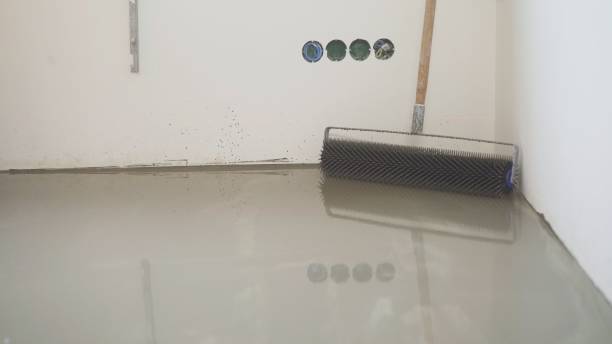 istock Charcoal roller on the self-leveling floor. Charcoal roller. Self-leveling floor tool. Self-leveling epoxy. Leveling with a mixture of cement floors 1319828925