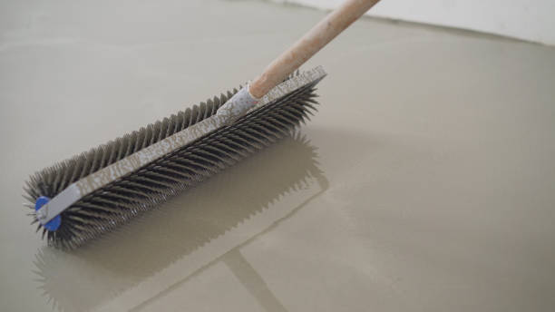 istock Charcoal roller on the self-leveling floor. Charcoal roller. Self-leveling floor tool. Self-leveling epoxy. Leveling with a mixture of cement floors 1319828949