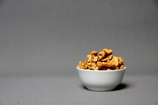 istock a bowl of walnut isolated on gray background - healthy eating concept 1319829295