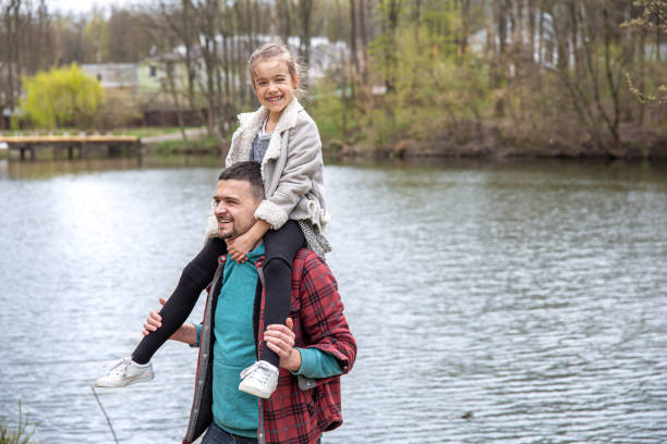 istock Dad and his little daughter in the woods for a walk by the river. 1319829894