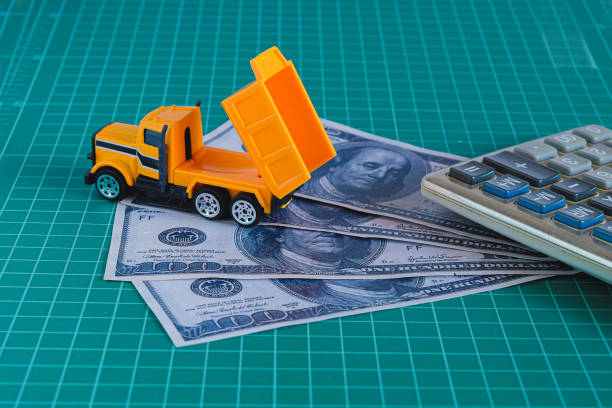 istock Construction vehicle on dollar banknote money. Financial concept. 1319830589
