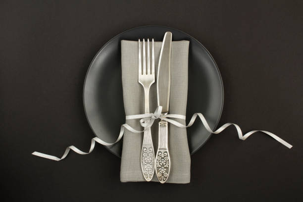 istock Top view of festive table setting on the black plate on the black background 1319831175