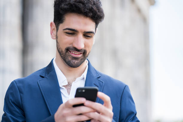 istock Businessman using his mobile phone outdoors. 1319832549