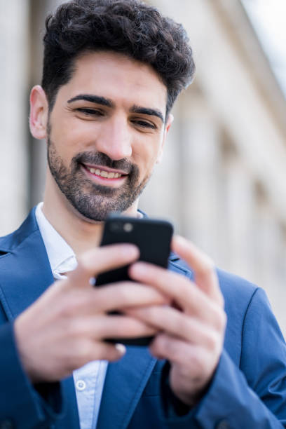 istock Businessman using his mobile phone outdoors. 1319832552