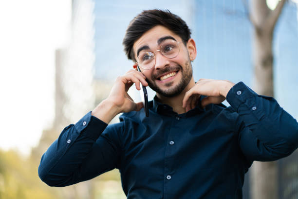 istock Young man talking on the phone outdoors. 1319832583