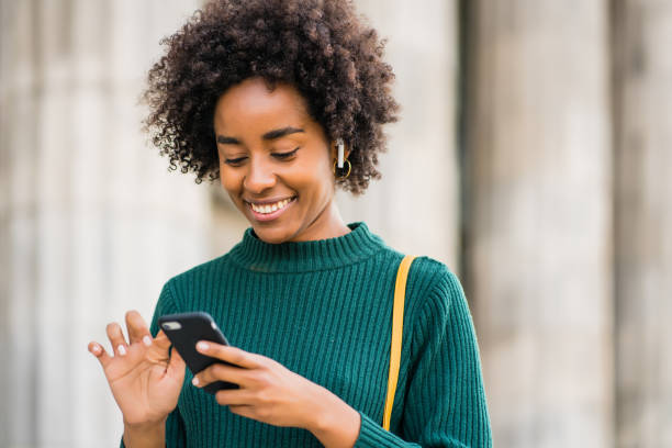 istock Business woman using her mobile phone outdoors. 1319832591