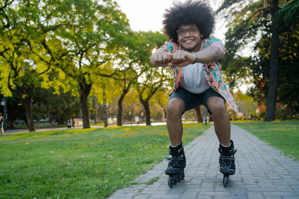 istock Latin man rollerskating outdoors. 1319832610