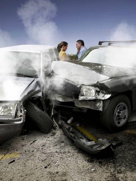istock Two people on a mobile phone after a car accident. 1319833381