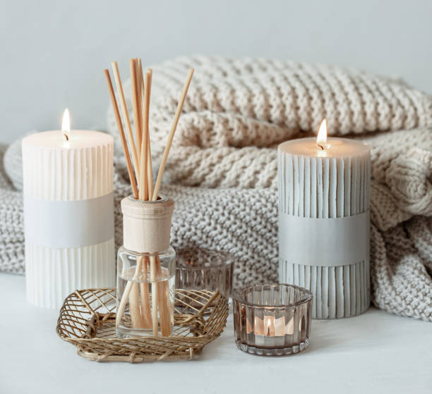 istock Cozy home composition with candles, aroma sticks and a knitted element. 1319834061