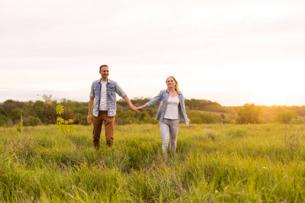 istock family is walking in a field 1319835294