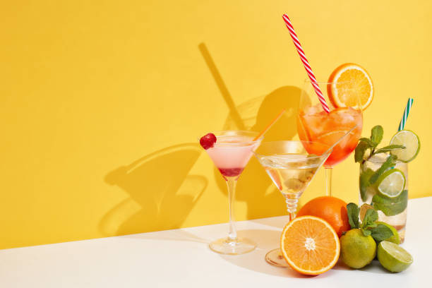istock Cocktails set. Glasses with various cold  beverages on double white yellow background with shadow. Copy space. Cocktail bar 1319835406